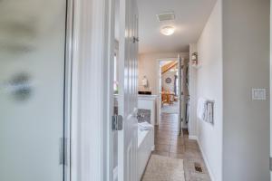 a white bathroom with a toilet and a hallway at SeaLaVie in Depoe Bay +66 photos