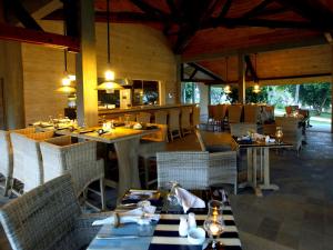 a dining room with tables and chairs in a restaurant at Hikka Tranz by Cinnamon in Hikkaduwa