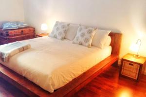 a bed in a room with two lamps and two tables at DIETRO L' ANGOLO Charme&Relax nel centro città in Bergamo