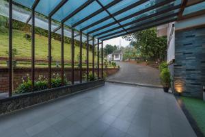 a glass house with a view of a garden at Trivers Resort Munnar in Munnar