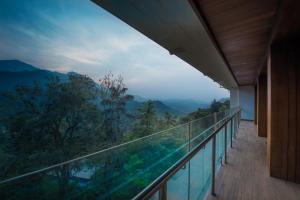 a balcony with a view of the mountains at Trivers Resort Munnar in Munnar