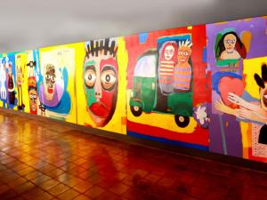 a wall with many different paintings on it at Hikka Tranz by Cinnamon in Hikkaduwa