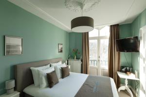 A bed or beds in a room at Boutique hotel Puur Zee - Adults Only