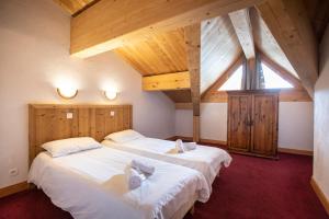Postel nebo postele na pokoji v ubytování Chalet des Neiges Plein Sud