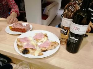 a table with two plates of food and a bottle of wine at Étape 85 in Saint-Vallier-de-Thiey