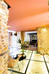 a living room with a stone wall at Molino Candeal Hotel Boutique & Apartamentos in Caniles