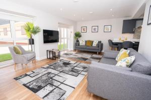 a living room with a couch and a table at Stable Court Apartments in Antrim