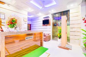 a lobby with a reception desk and a tv at Hotel Fabulous - Delhi International Airport in New Delhi