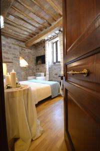 a bedroom with a bed and a table with candles at Case Brizi Assisi in Assisi