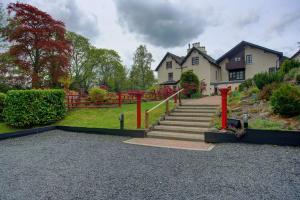 a house with a staircase in front of a house at Philipburn Hotel, BW Signature Collection in Selkirk