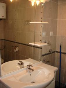 a bathroom with a sink and a glass shower at Apartments Medin Danilo in Petrovac na Moru