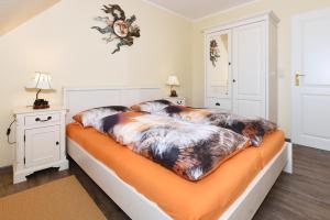 Postel nebo postele na pokoji v ubytování Ferienhaus Nordseeidyll