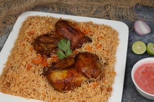 a plate of food with meat and rice at منتجع قرية الفقرة in As Sudayrah +43 photos