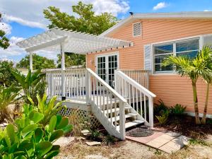 a house with a white staircase in front of it at Coral Cottage Retreat in Naples