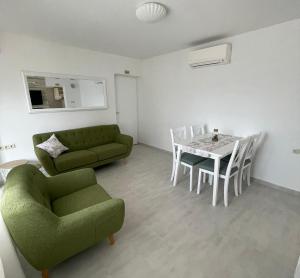 a living room with a couch and a table and chairs at Kuća za odmor Alf in Rab