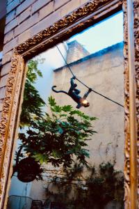 a mirror with a picture of a monkey with a tree at Hôtel Azur in Reims