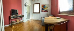una sala de estar con paredes rojas y una mesa de madera. en Home Old Verona, en Verona
