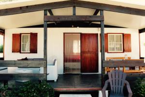 a porch of a house with a wooden door at Sardinia MongaHouse in Tertenìa