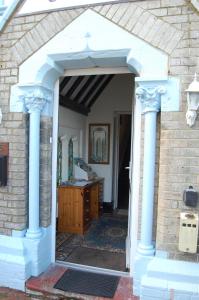 an entrance to a house with blue columns at The George B&B in Weymouth
