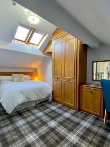 a bedroom with a bed and a skylight at Cumbrian Lodge in Seascale