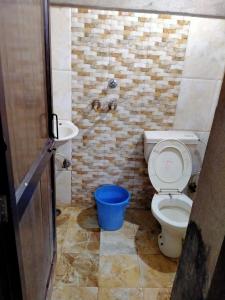 a bathroom with a toilet and a sink at SIDHU GUEST HOUES 5 minute walking distance golden Temple in Amritsar +51 photos