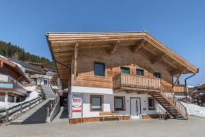 a log house with a balcony on top of it at Chalet Central - Top Cc8 in Königsleiten