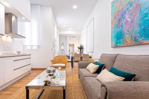 a living room with a couch and a table at Genteel Home Recaredo in Seville