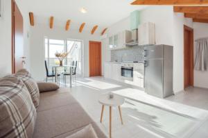 a living room with a couch and a kitchen at Villa Stipe in Podstrana