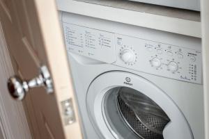 a washing machine sitting next to a door at 2 Bedroom Apartment in a Quiet Neighbourhood in St. Andrews