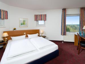 Postel nebo postele na pokoji v ubytování ACHAT Hotel Darmstadt Griesheim