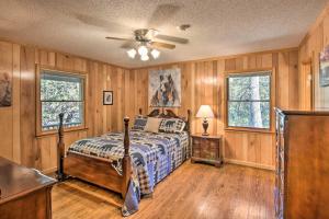 a bedroom with a bed and a ceiling fan at Secluded Lavinder Laurel Leaf Cottage Near Creek in Lakemont