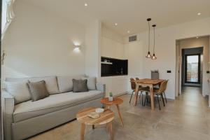 a living room with a couch and a table at Elsa Modern Apartments in Paleros