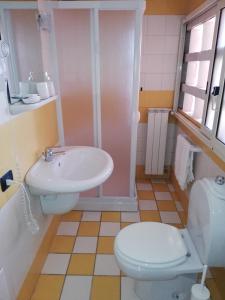 a bathroom with a toilet and a sink at Hotel Sibilla Residence in Pozzuoli +61 photos
