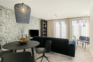 a living room with a couch and a table at DRL08 Luxury apartment with sauna in centre in Domburg