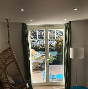 a room with a sliding glass door with a view at Close Quarters in Newton Ferrers
