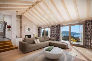 a living room with a couch and a table at Villa Tela with Pool in Zaboric