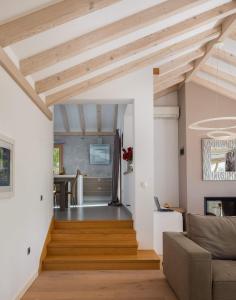 a living room with wooden ceilings and a staircase at Villa Tela with Pool in Zaboric