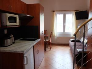 Kuchyň nebo kuchyňský kout v ubytování Apartments Sunce