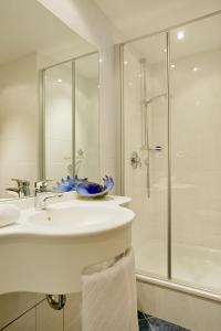 a white bathroom with a sink and a shower at Reck's Hotel-Restaurant in Salem