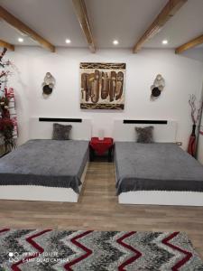 a bedroom with two beds and a rug at Studio Madi - Close to beach in Constanţa