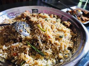 a plate of rice with a spoon in it at B.Rose House in Hatton