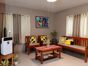 a living room filled with furniture and a tv at House Rental Banaba Tree in Samboan