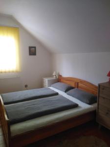a bedroom with two beds and a dresser and a window at Apartments Irena in Kranjska Gora