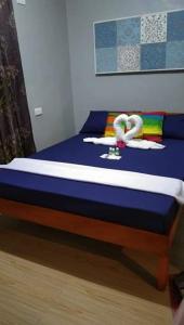 a bed with two flamingos on it in a room at House Rental Banaba Tree in Samboan