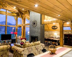 a living room with a fireplace and a clock at Mountain Hawk Park in Bansko