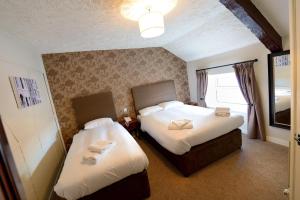 A bed or beds in a room at Savoy Country Inn