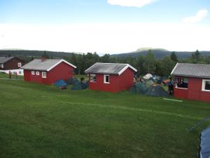 a small house with a bunch of tents on top of it at Skåbu Hytter og Camping in Skåbu