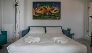 A bed or beds in a room at Panoramica attic room - Cala Gonone