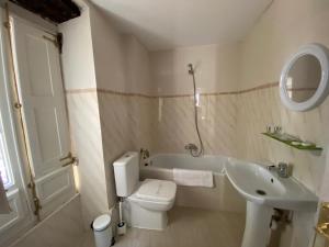 a bathroom with a toilet and a sink and a tub at HOSTERÍA SEÑORÍO DE BIZKAIA in Bakio