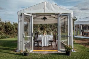 a white gazebo with a table in the grass at South Causey Inn in Stanley